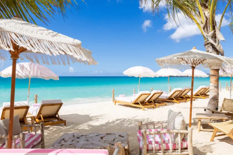 Pink cushions and white parasols looking out onto Simpson Bay beach